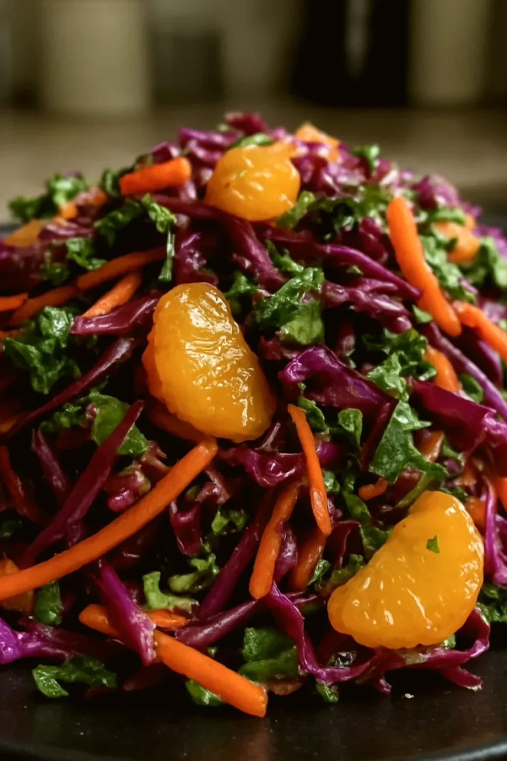 Mixed greens with orange segments and toasted pecans arranged in a large bowl, ready for salad assembly