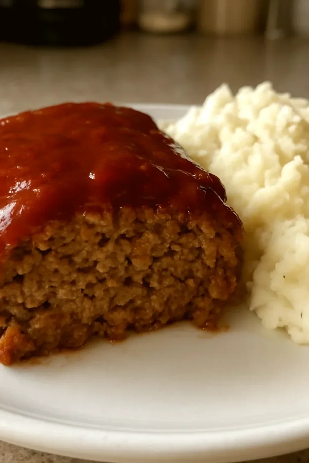 Ground beef mixture being combined in bowl showing proper texture before shaping into loaf